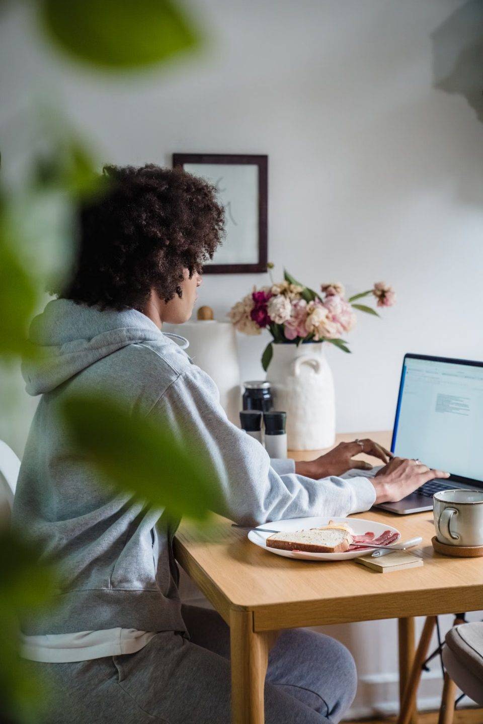 An agent reviewing documents at a home office desk